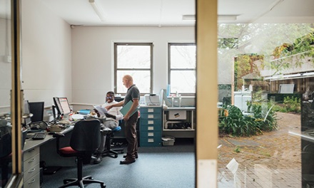 An aerial shot of two people collaborating in a work setting